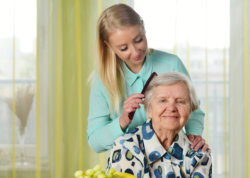 Caregiver assisting the old woman